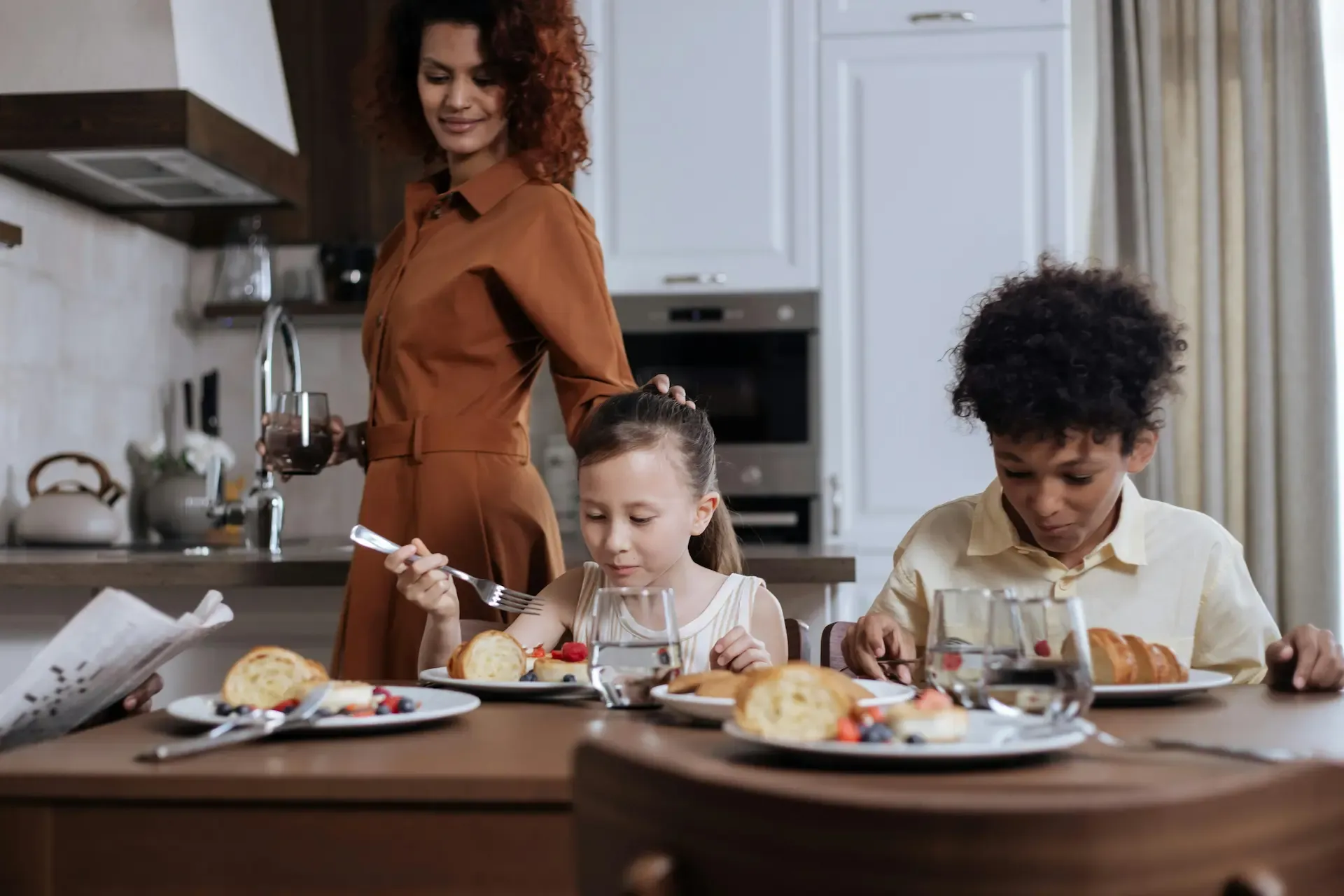 A family having breakfast with glasses of fresh clean water