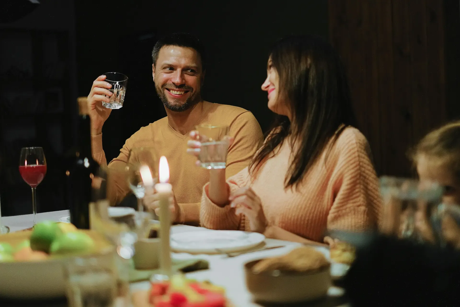 Family drinking water at the table