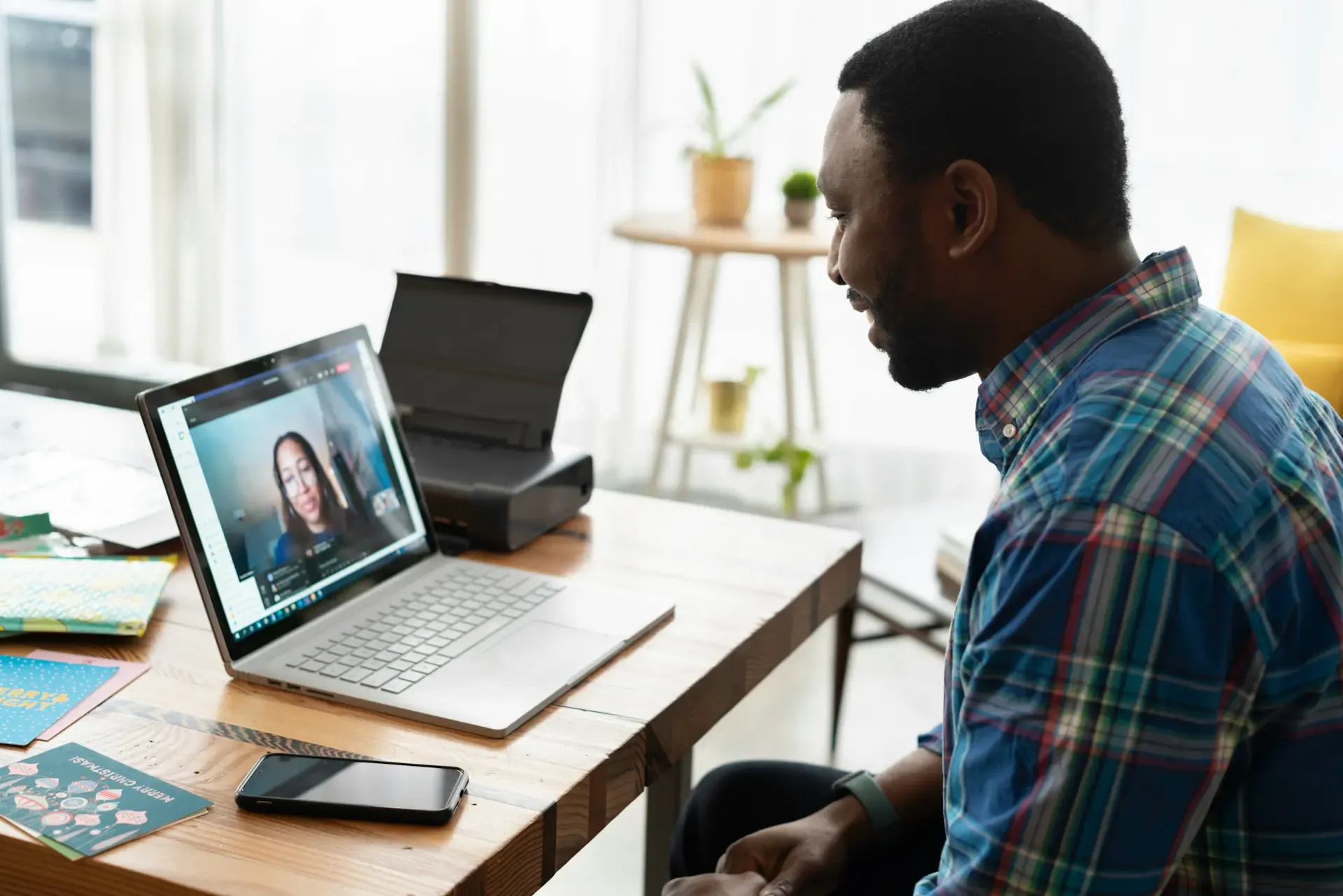 A man on a remote meeting using his laptop
