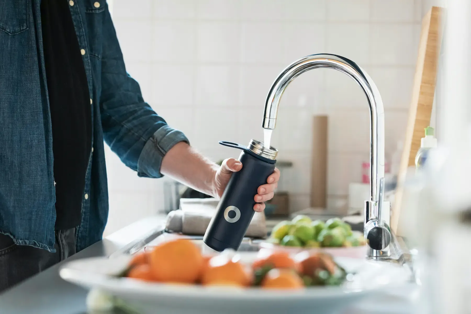 Man filling up water bottle