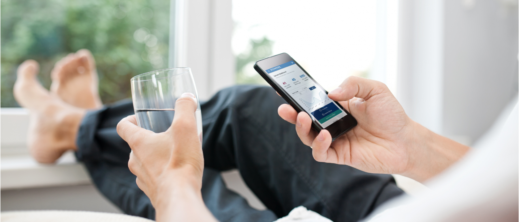 A man using the water softener app on his phone