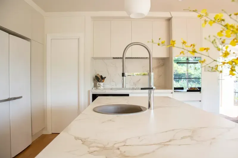 A kitchen sink on a marble counter