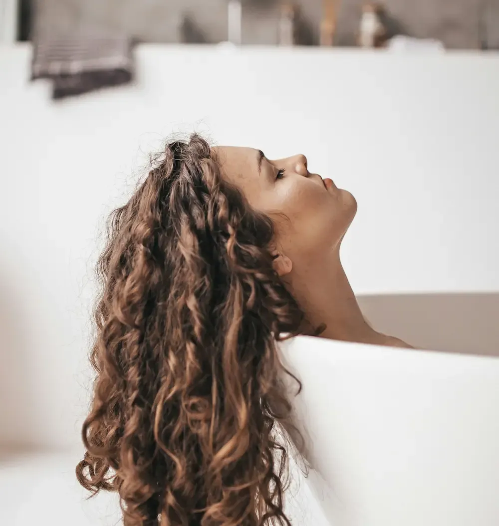 Woman in the bath washing hair